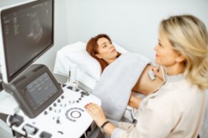 doctor performs ultrasound examination of a woman1